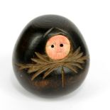 A 19th century Japanese carved corozo and ivory faced Daruma doll, height 3.6cm.Additional