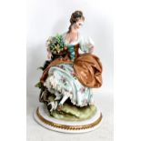 CAPODIMONTE; a late 19th/early 20th century porcelain figure of a girl with doves and flowers,