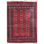 A Bokhara red ground rug, approx 191 x 128cm.