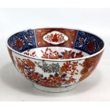 An early 20th century Japanese porcelain bowl decorated in the Imari palette, the central interior