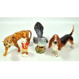 BESWICK; four figures comprising tiger, cuckoo (af), basset hound and 'Rupert the Bear' (4).