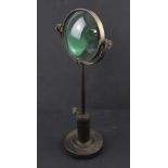 A Vintage cast and wrought iron magnifying glass on stand, base marked 'CD & Co London',