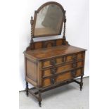 A 1930s oak dressing chest with arched bevelled swing mirror on barleytwist supports above a