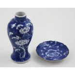 An Oriental blue and white baluster vase decorated with prunus blossom,