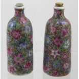 A pair of small Canton enamel-decorated Chinese porcelain scent bottles with red seal marks to the