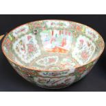 A large 19th century Canton enamel Chinese porcelain punch bowl with panel reserves featuring