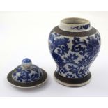 A small Chinese porcelain crackle glaze baluster vase and cover with brown banding to the lid,