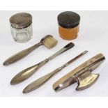 A George V hallmarked silver part manicure set to include tweezers, jars, brush etc, unboxed,