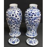 A pair of Chinese baluster vase and covers decorated with peonies and Chinese dragons in pursuit of