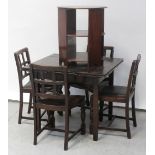 A dark stained oak draw-leaf table on square tapering legs with X-stretcher,