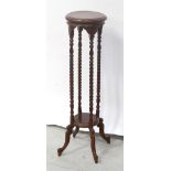 An Edwardian mahogany circular jardinière with four barleytwist columns to lower shelf on cabriole