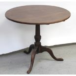 A late 19th/early 20th century mahogany circular table on column support and tripartite base,