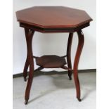 A 19th century French-style red walnut octagonal table on shaped cabriole legs united by a cross