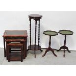 A nest of three contemporary mahogany brass inlaid tables with glass tops,