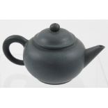 A small Yixing jade green ground teapot with seal mark to base, height 8.5cm.