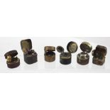 Six travelling ink wells of various sizes shapes and forms,