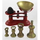 A set of vintage cast iron scales with weights and four free-standing brass weights (2).