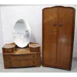 A c1950s oak two-door wardrobe, an oval mirror-back dressing table,