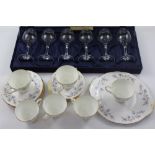 A set of six Italian engraved wine glasses and a vintage tea service with blue floral decoration