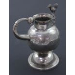 A small white metal spout-less milk jug in the Russian style,