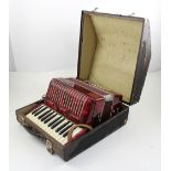 A cased Bell accordion.