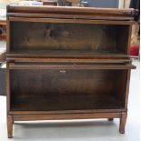 An oak two-tier Globe Wernicke stacking bookcase on shaped cabriole legs, height 91cm.