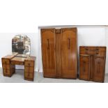 An Art Deco style oak bedroom suite comprising a two-door wardrobe,