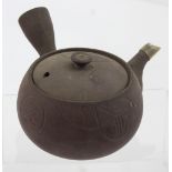 A Yixing teapot with abstract Oriental design to the lid, height 8cm.