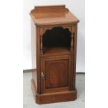 An Edward VII French walnut nightstand with galleried back surmounting an open well flanked by