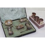 A cased five-piece hallmarked silver cruet and cased napkin rings, Walker & Hall, Sheffield 1912,