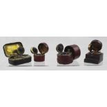 Four travelling ink wells, two of cylindrical form in red Moroccan cover,