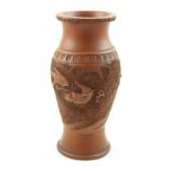 A Chinese terracotta baluster vase decorated with dragon in pursuit of the Flaming Pearl of Wisdom,