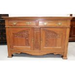 A late Victorian walnut sideboard base, two frieze drawers surmounting two cupboards,