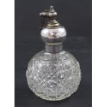 A cut glass ovoid perfume atomiser with hallmarked silver mount, London 1916.