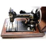 A cased vintage sewing machine.