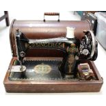 An oak-cased Singer sewing machine, ref.F8821785.