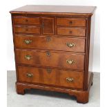 A mahogany TV display cabinet formed as a faux chest of drawers,