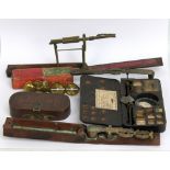 A group of brass sovereign scales to include a Harrison example, a cased I.W. Herberts London