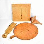 A large 19th century pine circular bread or pizza paddle, diameter 52.5cm, a pine chopping board,