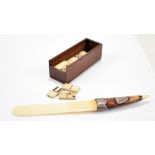 A Victorian ivory and stained ivory letter opener modelled as a miniature page turner with white