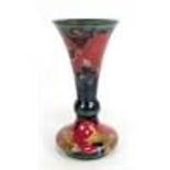 MOORCROFT; a 'Pomegranate' pattern tubeline decorated bottle vase with flared rim, impressed marks
