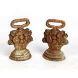 A pair of cast iron door stops modelled as baskets of fruit (2).