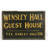 A painted wooden double sided sign for Wensley Hall Guest House, length 81cm.