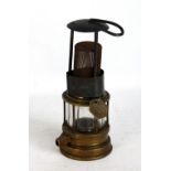 An unnamed safety lamp with iron and gauze upper section, glass and brass lower section and with