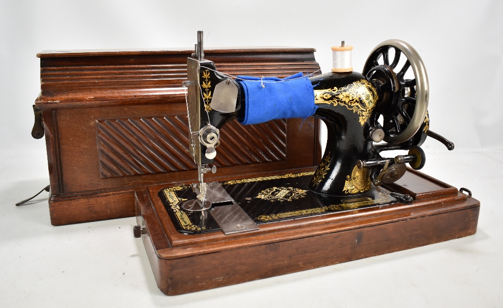 A walnut-cased Singer sewing machine.