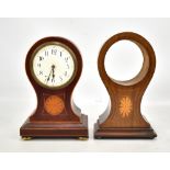 An Edwardian mahogany and inlaid mantel clock, the circular enamelled dial set with Arabic numerals,