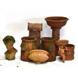 Eight pieces of reconstituted terracotta coloured garden ornamentation including two rhubarb