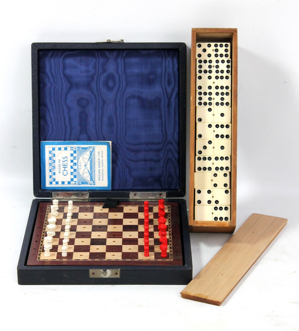 A cased travelling chess set with board, all pieces and instructions and a wooden cased set of