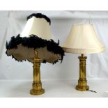 A pair of large modern brass table lamps.