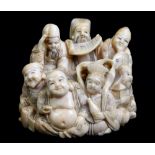 A good and large Japanese Meiji period carved ivory netsuke modelled as a group of figures, signed